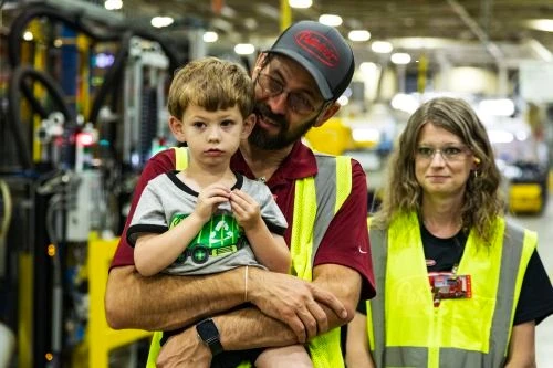 Make-A-Wish recipient James Burr and his parents touring the Peterbilt manufacturing facility in Denton, Texas.