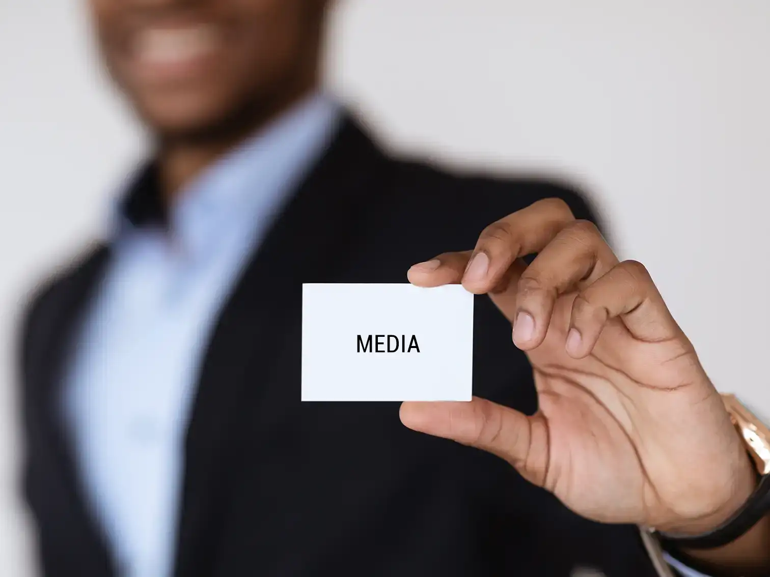 man holding media icon in hand