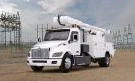 Peterbilt Model 548EV Electric Medium Duty truck with a bucket body in an electrical substation - Thumbnail